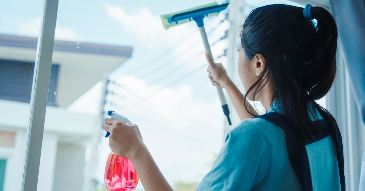 Professional cleaner working on exterior glass